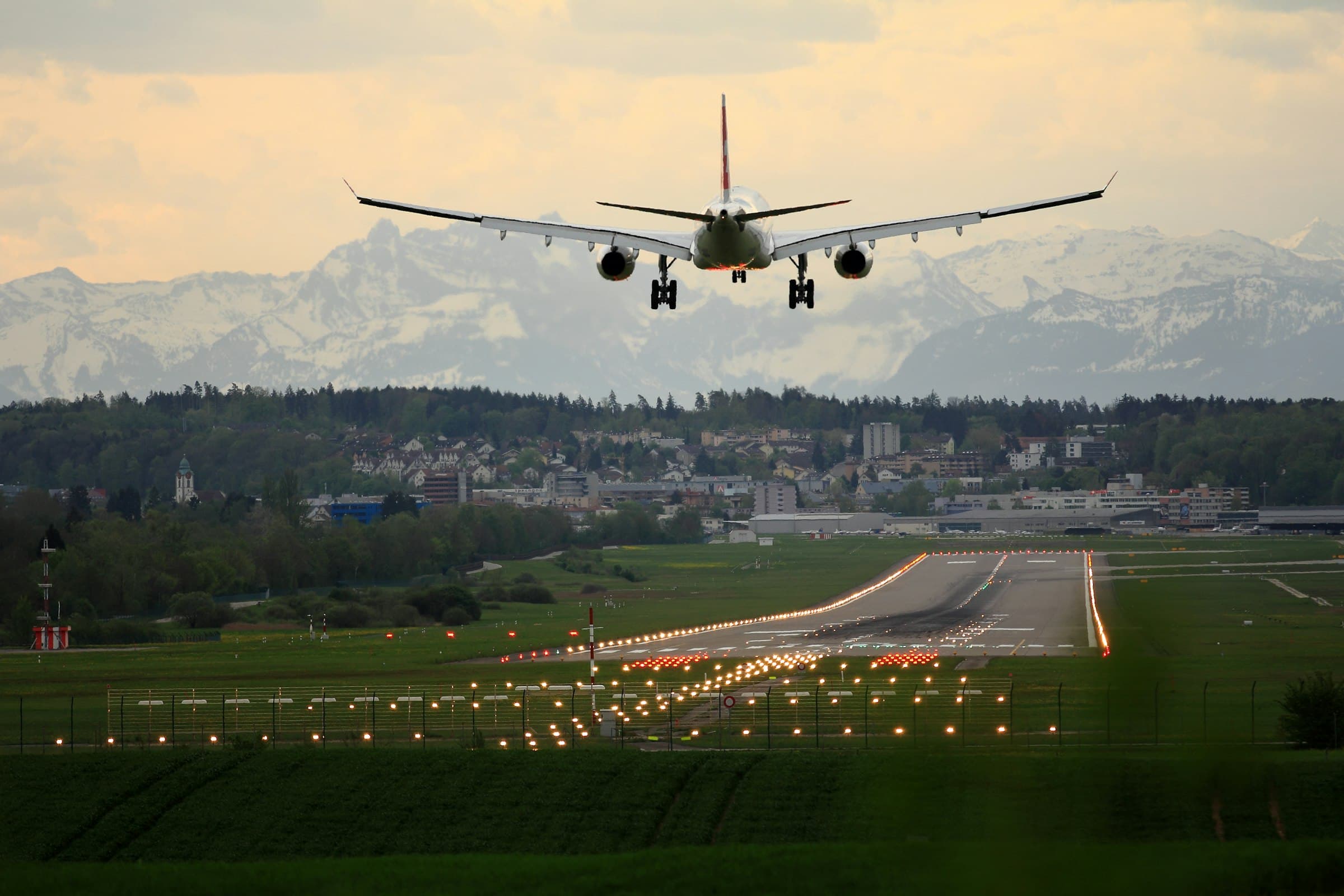 Passenger jet landing with mountains behind